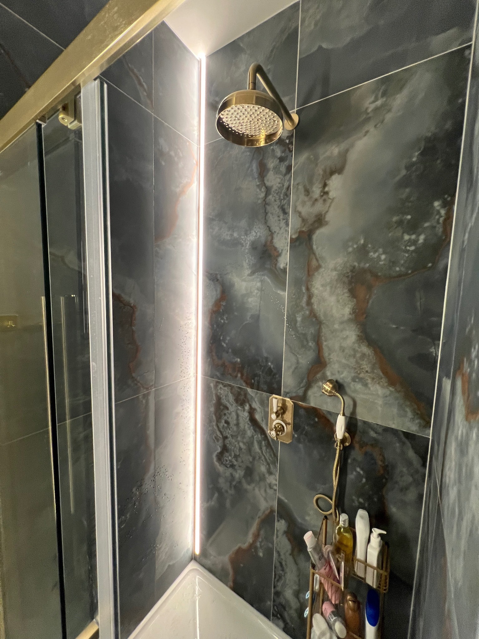 LED feature lighting installed beside a shower in a modern bathroom